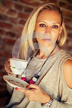 Young pretty woman drinking coffee