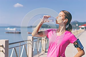 Young pretty woman drinking water