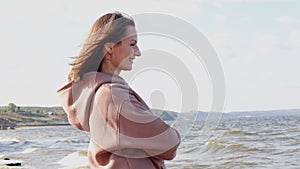 Young pretty woman enjoying the view of the sea, resting, tourism concept