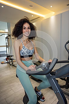 Young pretty woman on a exercycle