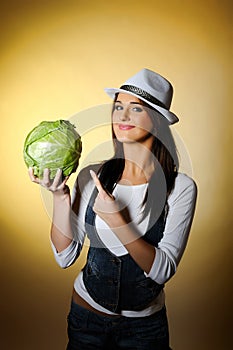 Young pretty woman with green cabbage smiling