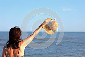 Young pretty woman and her big straw hat