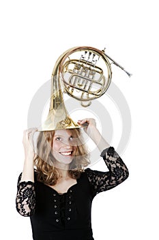 Young pretty woman holding french horn