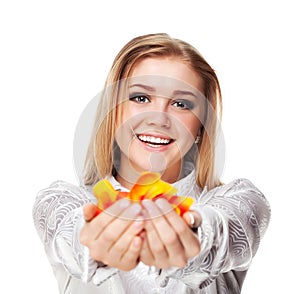 Young pretty woman holding rose petals