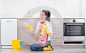 Woman cleaning kitchen floor