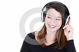 Young pretty woman listening to music in headphones on white background