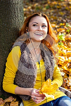 Young pretty woman in the park in autumn