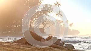 Young pretty woman practices yoga against endless ocean