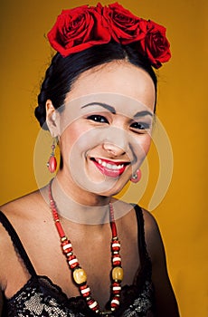 Young pretty woman with red roses on hairstyle smiling happy on