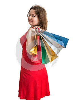 Young pretty woman is shopping with colorful bags. Isolated on white.