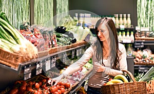 young pretty woman shopping for fresh healthy food in the supermarket