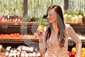 young pretty woman shopping for fresh healthy food in the supermarket