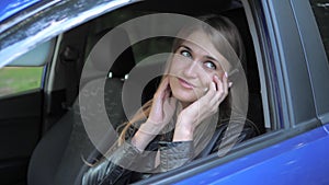 Young Pretty Woman Sitting In The Car And Have Fun Talking On The Phone