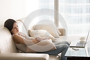 Young pretty woman sleeping on couch, taking nap on sofa