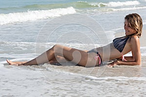 Young pretty woman sunbathing on the beach, Florida, USA