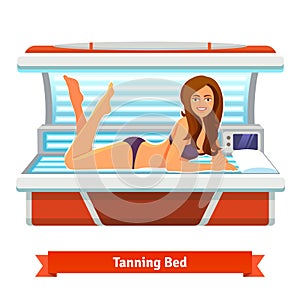 Young pretty woman in tanning bed. Artificial tan
