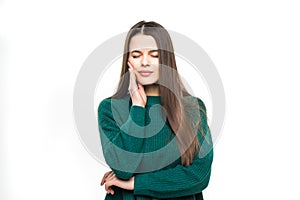 Young pretty woman theeth pain wearing in green sweater isolated on white background