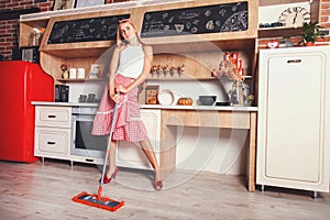 Woman Is Dreaming While Cleaning photo