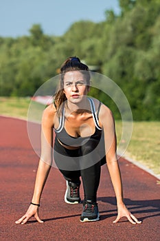 Young and pretty woman training in the outdoor fitness park