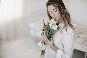 Young pretty woman with tulips flowers bouquet, Spring calm and happy portrait