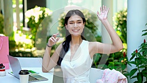 Young pretty woman waving a hand in greeting
