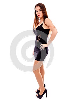Young pretty woman wearing black evening dress and posing in stu