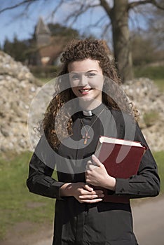 Young priest visiting her parish in the countryside