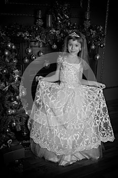 Young princess in a white dress with a tiara on her head , Vintage black and white photo