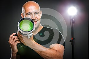 Young, pro male photographer in his studio