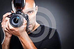 Young, pro male photographer in his studio during a photo shoot