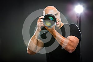 Young, pro male photographer in his studio during a photo shoot