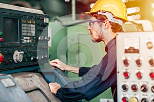 Young profession technician engineer operate heavy machine to automated CNC in factory