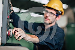 Young profession technician engineer operate heavy machine to automated CNC in factory, close-up worker hand