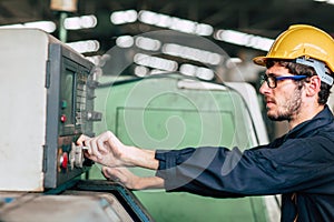 Young profession technician engineer operate heavy machine to automated CNC in factory, close-up worker hand