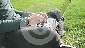 Young professional business man analyzing corporate information and data using his computer and mobile smatrphone