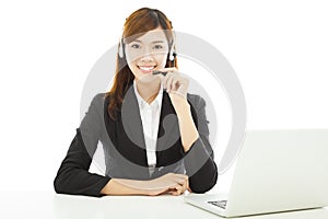 Young professional business woman with earphone and laptop