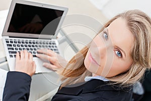 Young professional business woman using her laptop