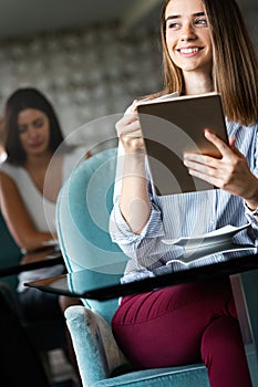 Young professional businesswoman sitting at table at cafe