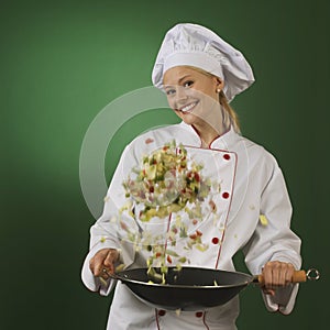 Young professional cook on green background - squa