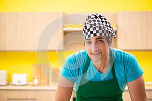 The young professional cook preparing in kitchen