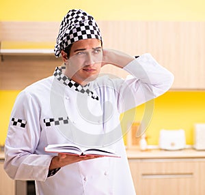 Young professional cook preparing in kitchen