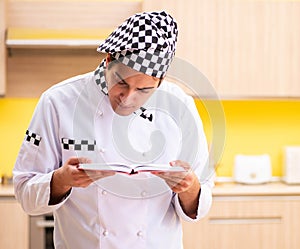 Young professional cook preparing in kitchen