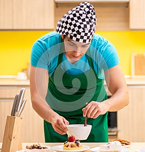 Young professional cook preparing in kitchen