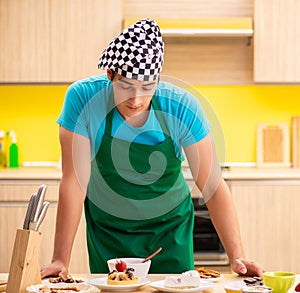Young professional cook preparing in kitchen