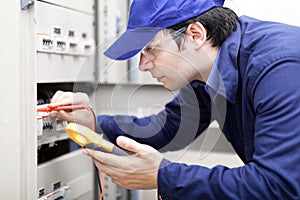 Young professional electrician at work