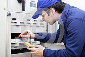 Young professional electrician while working