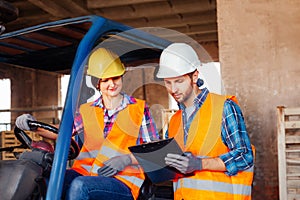 Young professional factory workers discussing working issues