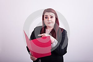 Young professional female holding an open a red file folder pointing at it