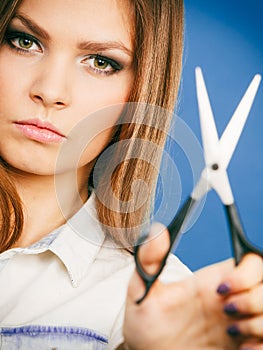 Young professional hairdresser with scissors.