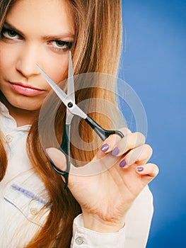 Young professional hairdresser with scissors.